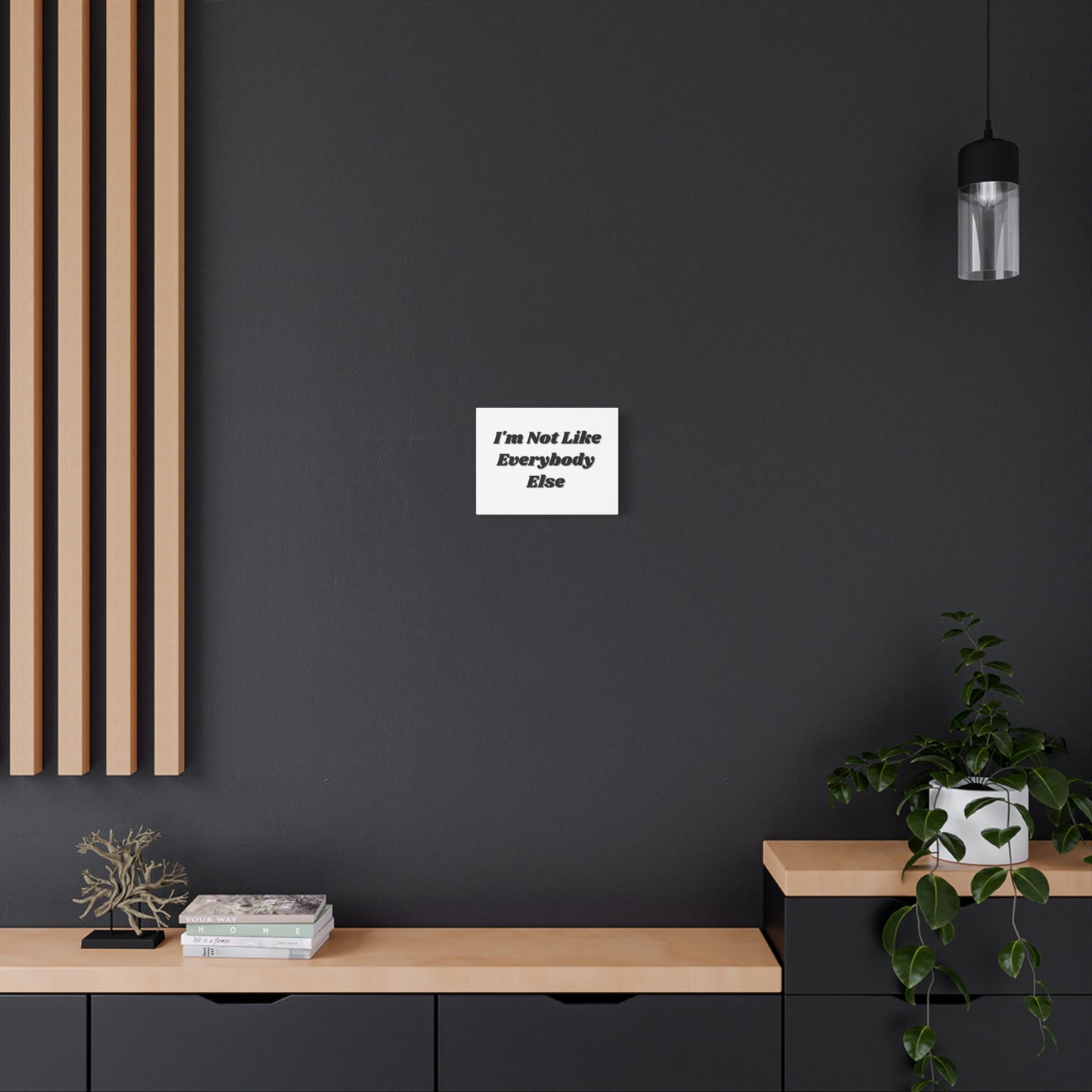 Wall Art- Inspirational Canvas - "I'm Not Like Everybody Else" hanging on a black wall