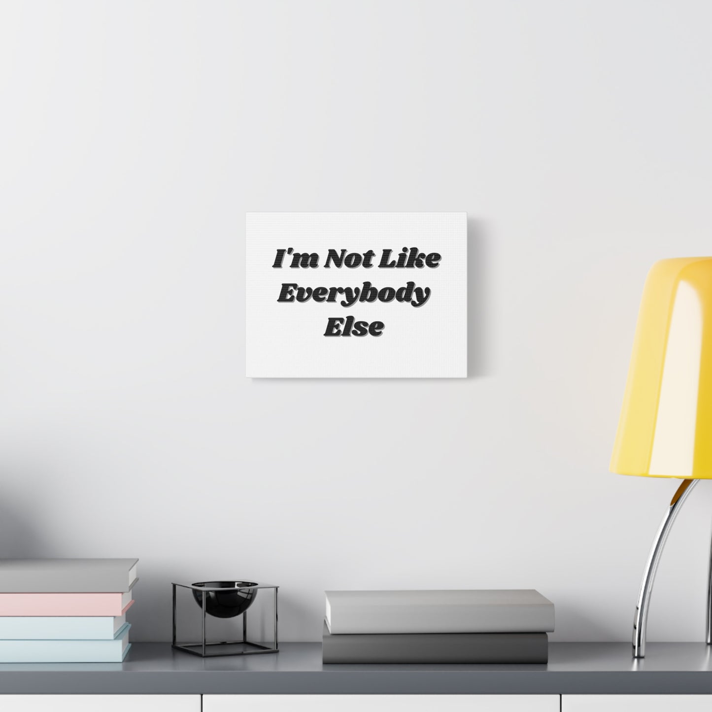 Wall Art- Inspirational Canvas - "I'm Not Like Everybody Else" hanging on a white wall
