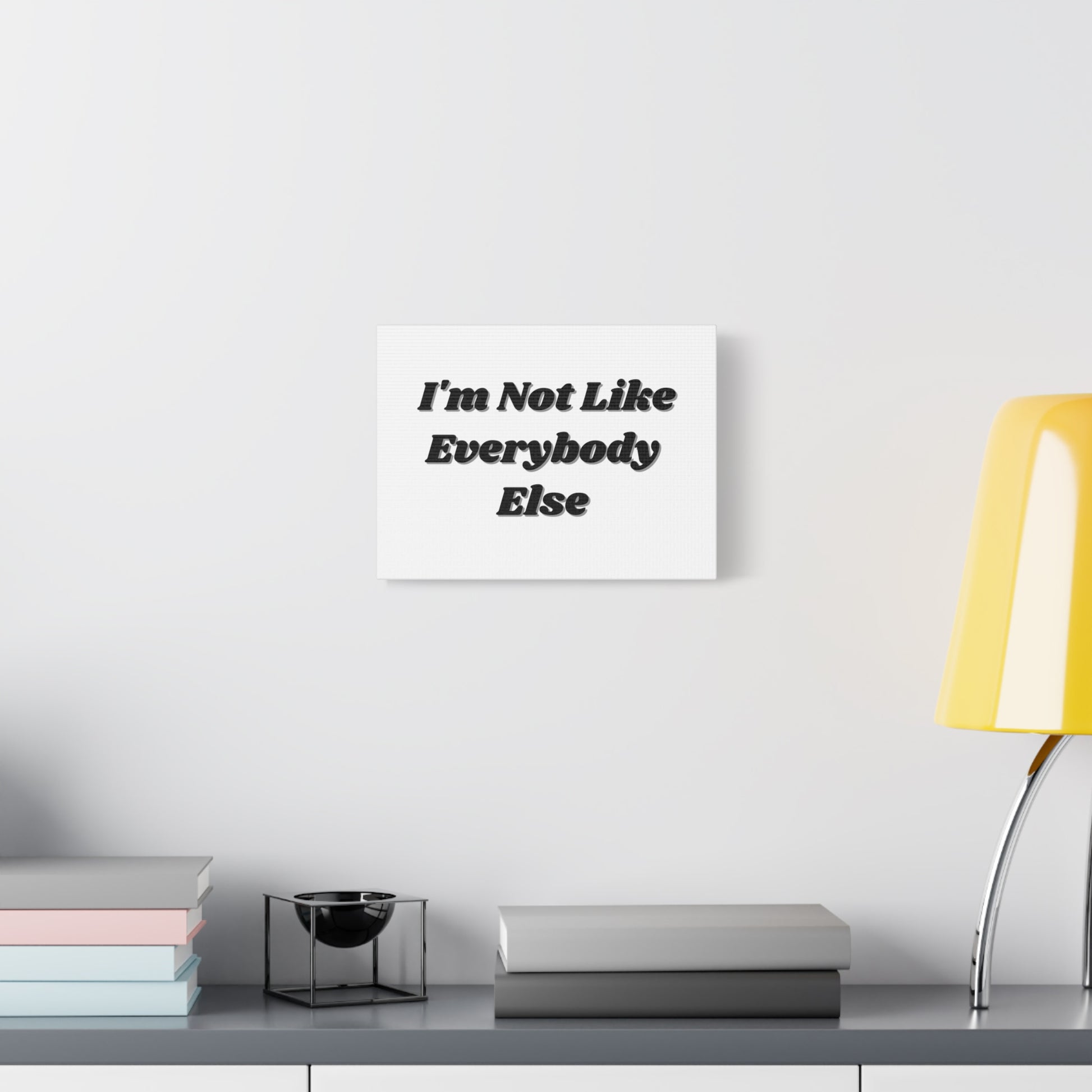 Wall Art- Inspirational Canvas - "I'm Not Like Everybody Else" hanging on a white wall